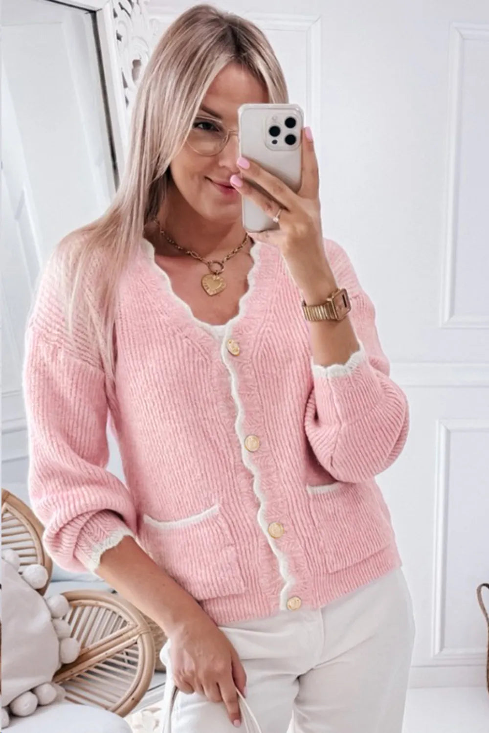 Pink knit cardigan with scalloped edges and gold-tone buttons styled for brunch or office.