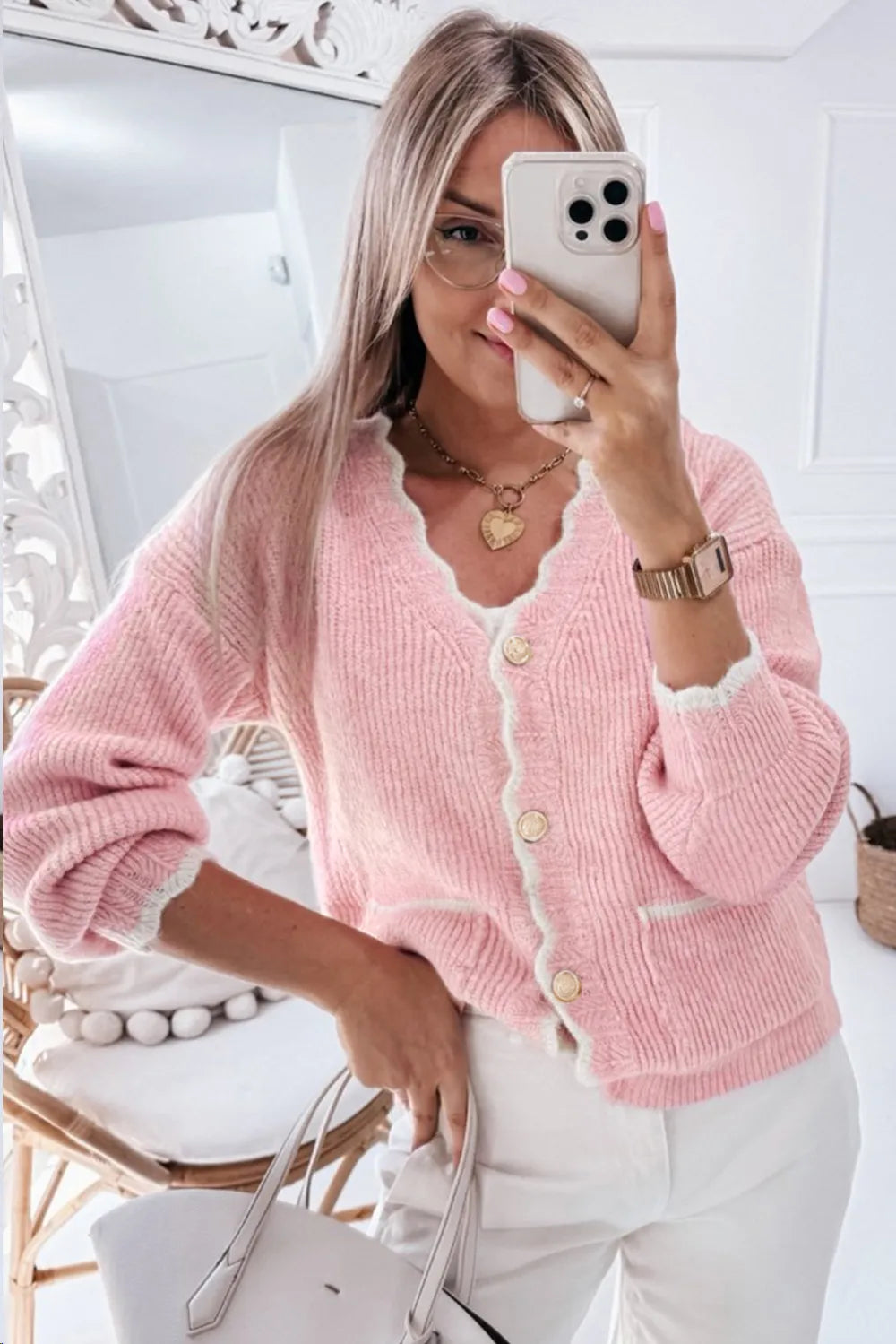 Modern feminine rose-pink cardigan with elegant contrast trim and ribbed knit texture.