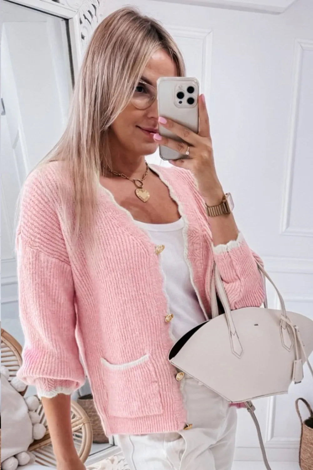 Gold-buttoned rose blush knit cardigan with soft scalloped edging in lifestyle outfit.
