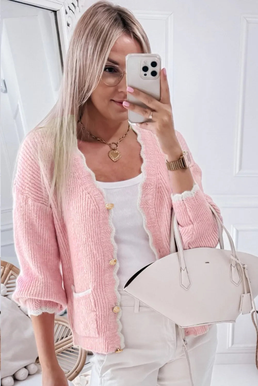 Lightweight pastel pink V-neck cardigan with white scalloped detail, perfect for layering.